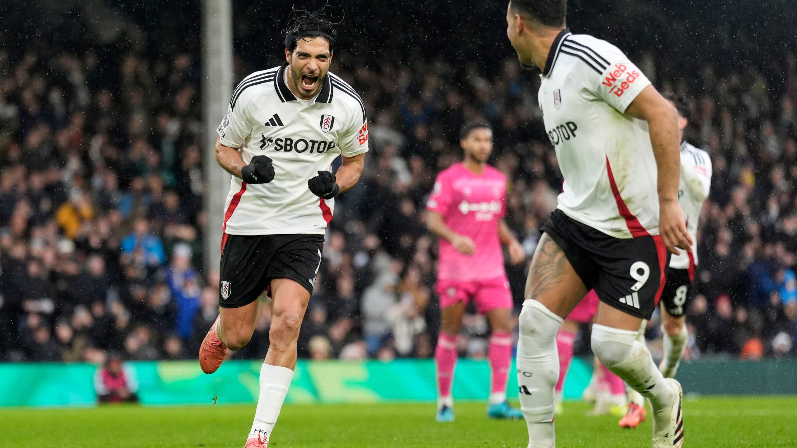 Fulham's Raul Jimenez, left, celebrates after scoring his sides first goal from the penalty spot during the English Premier League soccer match between Fulham and Ipswich Town at Craven Cottage stadium, London, Sunday Jan. 5, 2025. (Andrew Matthews/PA via AP)