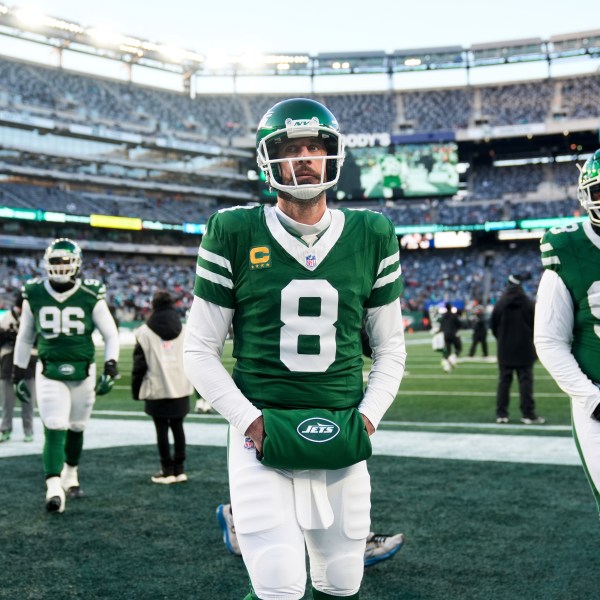 New York Jets quarterback Aaron Rodgers (8) looks on before an NFL football game against the Miami Dolphins, Sunday, Jan. 5, 2025, in East Rutherford, N.J. (AP Photo/Seth Wenig)