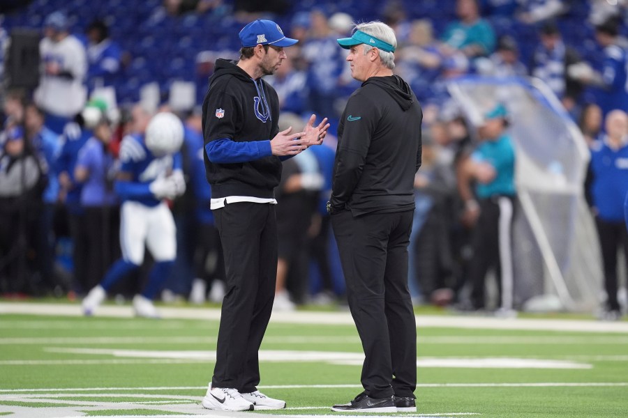 Indianapolis Colts head coach Shane Steichen, left, and Jacksonville Jaguars head coach Doug Pederson talk on the field before an NFL football game, Sunday, Jan. 5, 2025, in Indianapolis. (AP Photo/Michael Conroy)