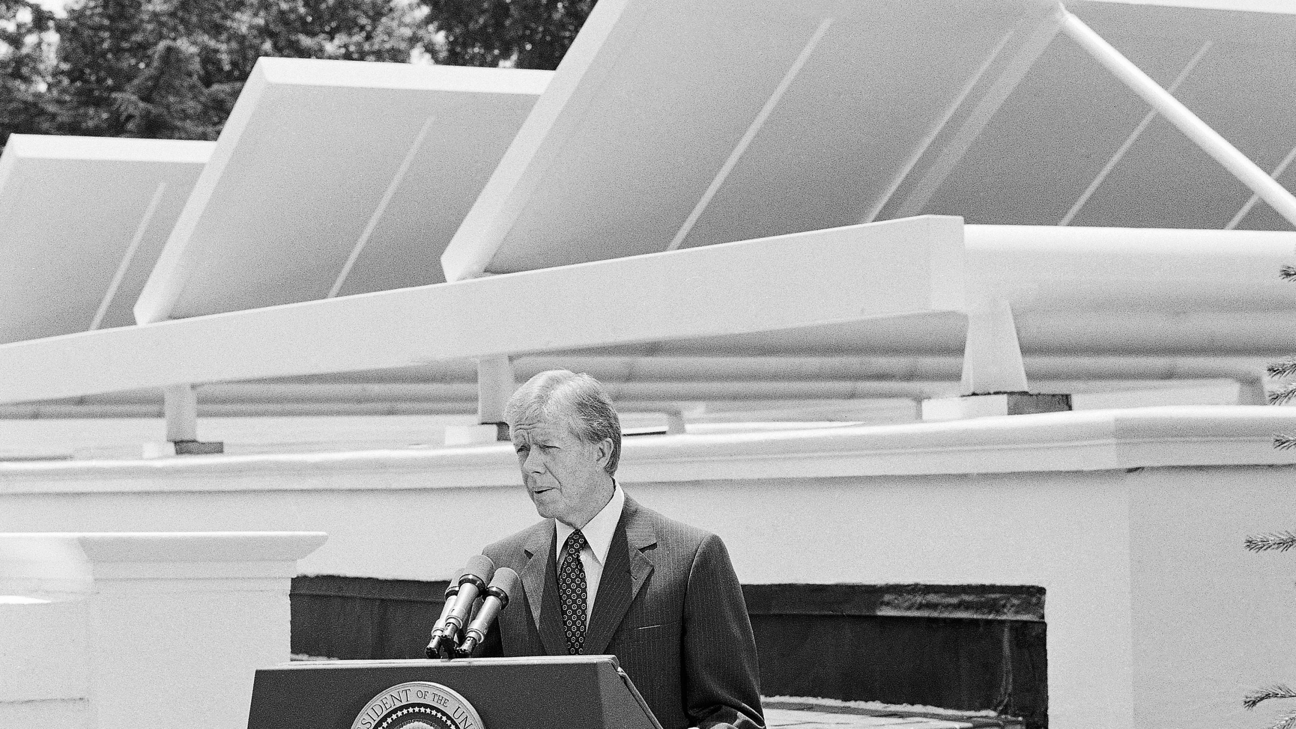 FILE - President Jimmy Carter speaks against a backdrop of solar panels at the White House, June 21, 1979, in Washington. (AP Photo/Harvey Georges, File)