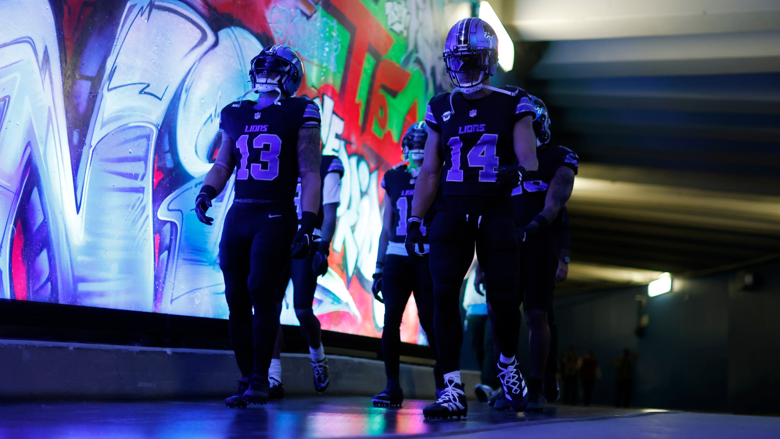 Detroit Lions running back Craig Reynolds (13) and wide receiver Amon-Ra St. Brown (14) walk to the field before an NFL football game against the Minnesota Vikings, Sunday, Jan. 5, 2025, in Detroit. (AP Photo/Rey Del Rio)