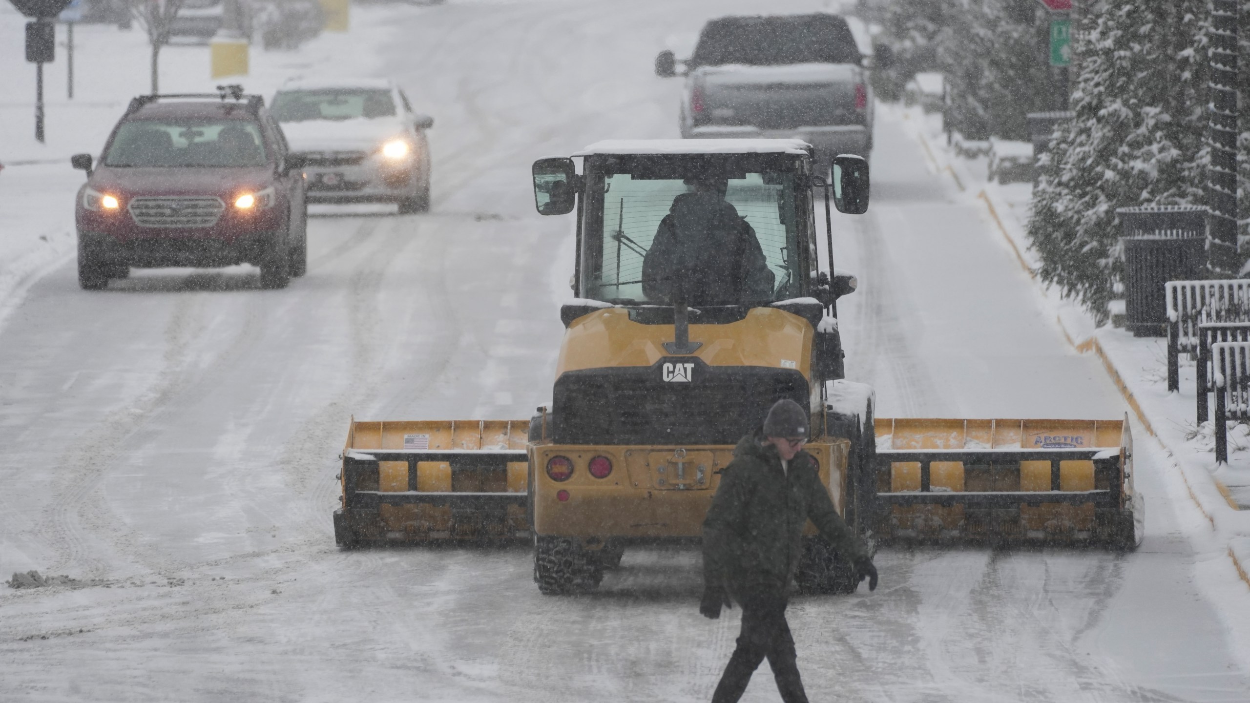 A plow clears a parking lot during a winter storm, Sunday, Jan. 5, 2025, in Cincinnati. (AP Photo/Joshua A. Bickel)