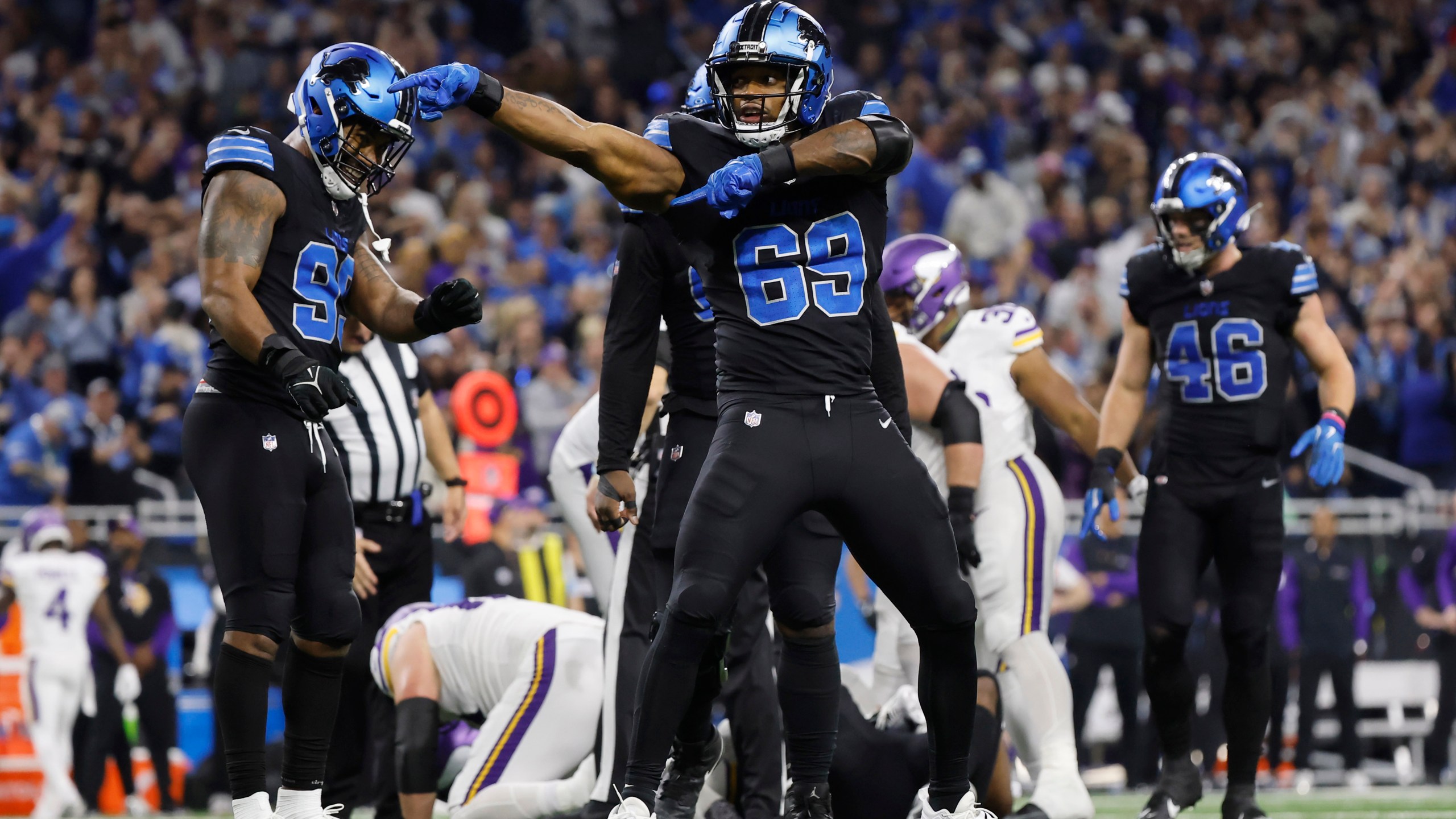 Detroit Lions linebacker Al-Quadin Muhammad (69) celebrates after helping to sack Minnesota Vikings quarterback Sam Darnold during the second half of an NFL football game Sunday, Jan. 5, 2025, in Detroit. (AP Photo/Rey Del Rio)