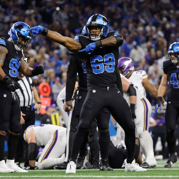 Detroit Lions linebacker Al-Quadin Muhammad (69) celebrates after helping to sack Minnesota Vikings quarterback Sam Darnold during the second half of an NFL football game Sunday, Jan. 5, 2025, in Detroit. (AP Photo/Rey Del Rio)