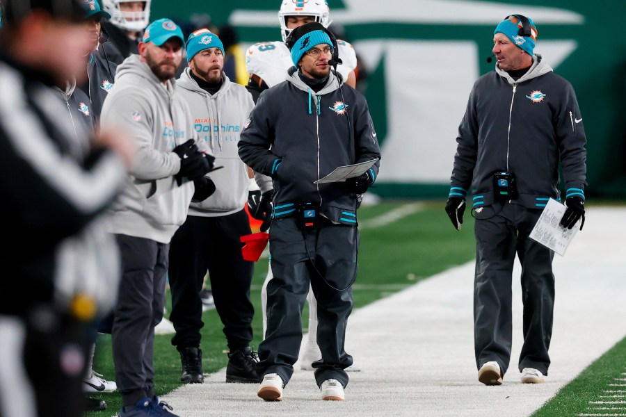 Miami Dolphins head coach Mike McDaniels, center, walks on the sideline during the second half of an NFL football game against the New York Jets, Sunday, Jan. 5, 2025, in East Rutherford, N.J. (AP Photo/Noah K. Murray)