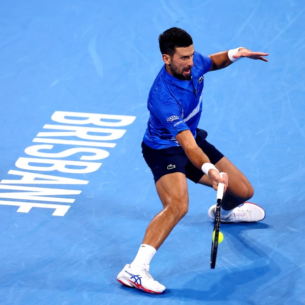 Serbia's Novak Djokovic plays a forehand to USA's Reilly Opelka during their match at the Brisbane International in Brisbane, Australia, Friday, Jan. 3, 2025. (AP Photo/Pat Hoelscher)