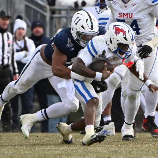 Penn State defensive end Abdul Carter sacks SMU quarterback Kevin Jennings during the second half in the first round of the College Football Playoff, Saturday, Dec. 21, 2024, in State College, Pa. (AP Photo/Barry Reeger)