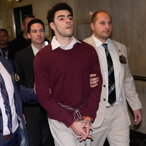 Luigi Mangione is escorted into Manhattan Criminal court for his arraignment on state murder and terror charges in the killing of UnitedHealthcare CEO Brian Thompson, Monday, Dec. 23, 2024, in New York. (AP Photo/Seth Wenig)