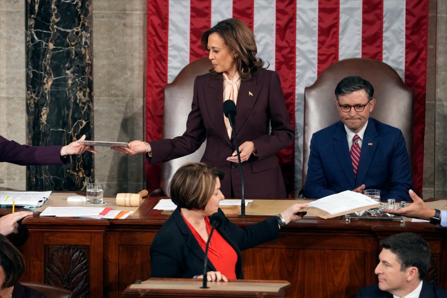 Vice President Kamala Harris is handed a certification as House Speaker Mike Johnson of La., watches while teller Sen. Amy Klobuchar, D-Minn., stands at the clerk's podium as a joint session of Congress convenes to confirm the Electoral College votes, affirming President-elect Donald Trump's victory in the presidential election, Monday, Jan. 6, 2025, at the U.S. Capitol in Washington. (AP Photo/Matt Rourke)