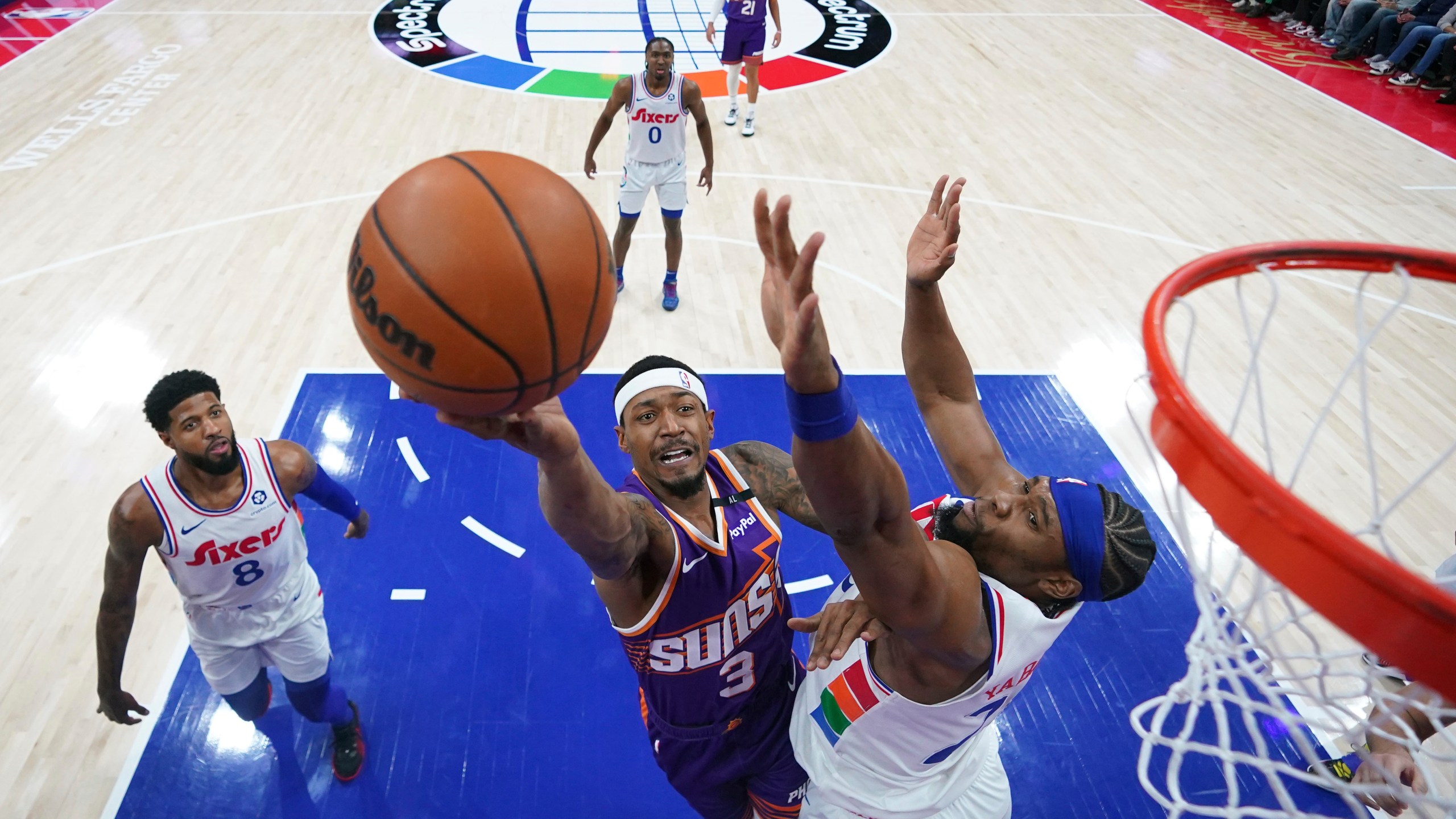 Phoenix Suns' Bradley Beal, center, goes up for a shot against Philadelphia 76ers' Guerschon Yabusele, right, during the first half of an NBA basketball game, Monday, Jan. 6, 2025, in Philadelphia. (AP Photo/Matt Slocum)