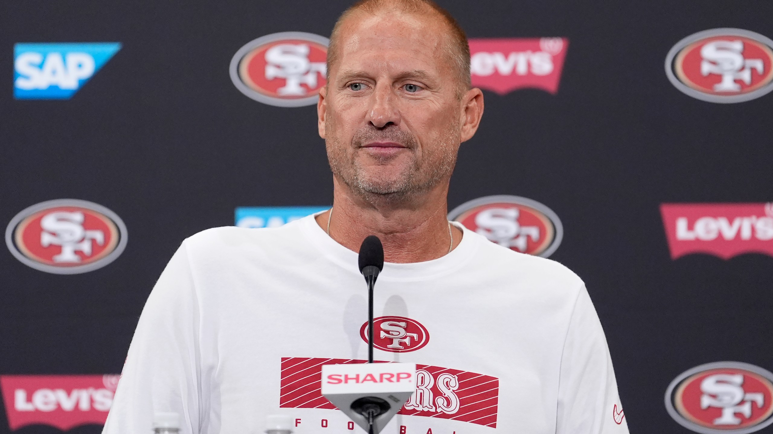 FILE - San Francisco 49ers special teams coordinator Brian Schneider speaks at a news conference during NFL football training camp in Santa Clara, Calif., July 30, 2024. (AP Photo/Jeff Chiu, File)