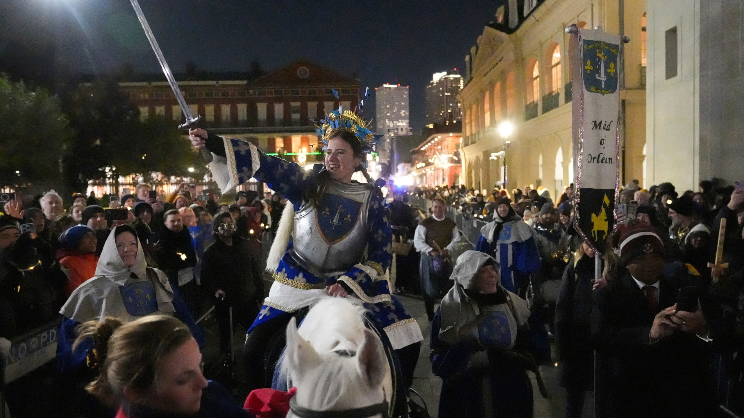 A person dressed as Joan of Arc holds a sword on-top of a horse during the annual Krewe de Jeanne d'Arc parade, kicking off the Mardi Gras season, in New Orleans, Monday, Jan. 6, 2025. (AP Photo/Gerald Herbert)