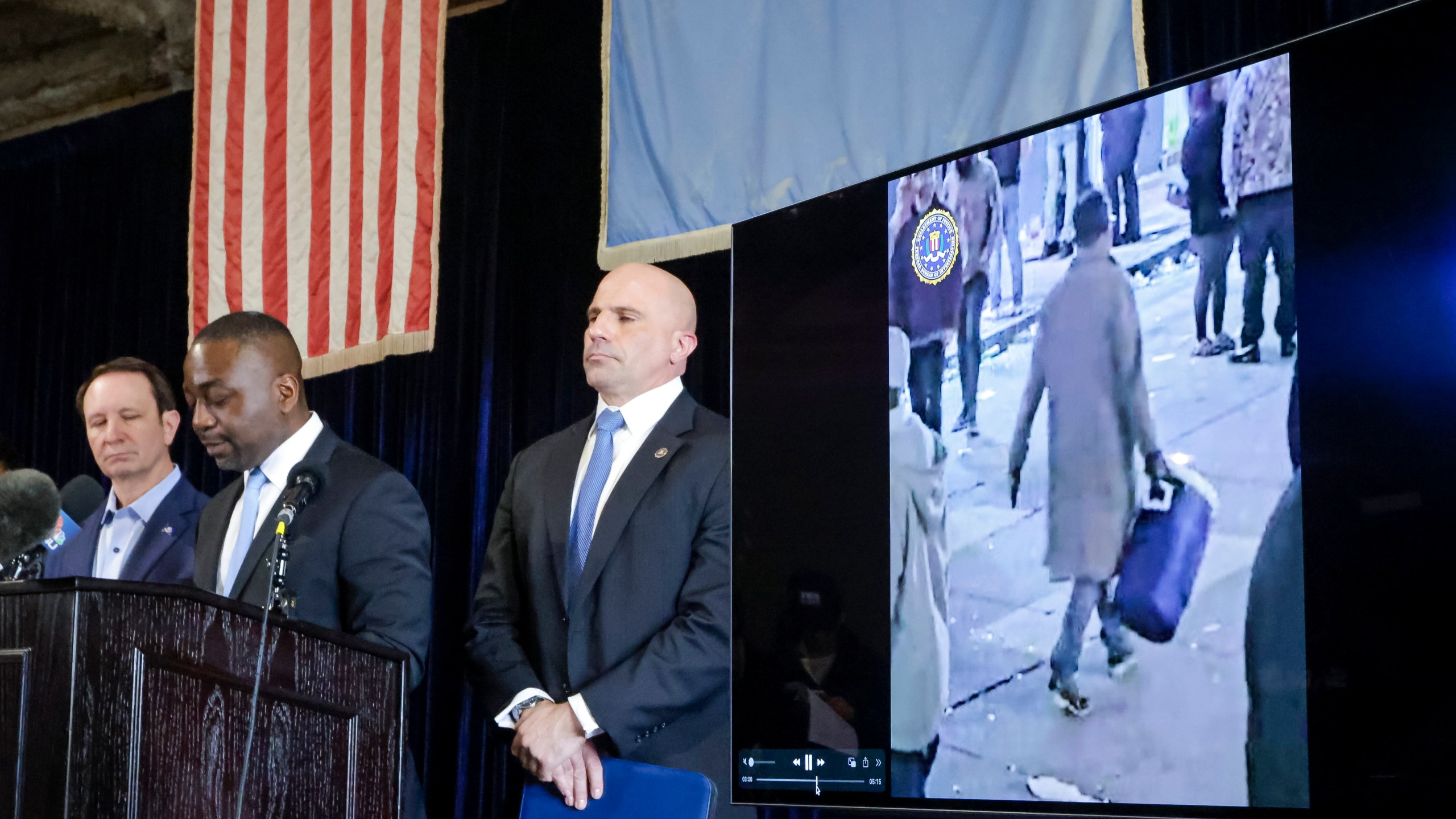 Lyonel Myrthil, special agent in charge of the New Orleans field office, second from left, shows footage of Shamsud-Din Jabbar, the man who carried out an attack on New Orleans' Bourbon Street on New Year's Day, during a news conference in a secure garage at the FBI Headquarters in New Orleans, Sunday, Jan. 5, 2025. (Scott Threlkeld/The Times-Picayune/The New Orleans Advocate via AP)