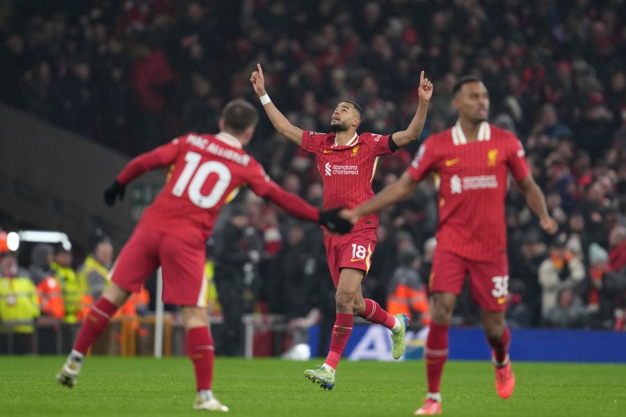 Liverpool's Cody Gakpo, center, celebrates after scoring his side's first goal against Manchester United during the English Premier League soccer match at the Anfield stadium in Liverpool, England, Sunday, Jan. 5, 2025. (AP Photo/Jon Super)