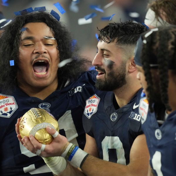 Penn State players celebrate after the Fiesta Bowl College Football Playoff game against Boise State, Tuesday, Dec. 31, 2024, in Glendale, Ariz. (AP Photo/Ross D. Franklin)