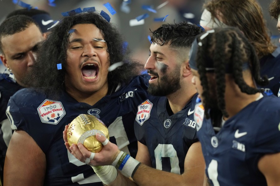 Penn State players celebrate after the Fiesta Bowl College Football Playoff game against Boise State, Tuesday, Dec. 31, 2024, in Glendale, Ariz. (AP Photo/Ross D. Franklin)