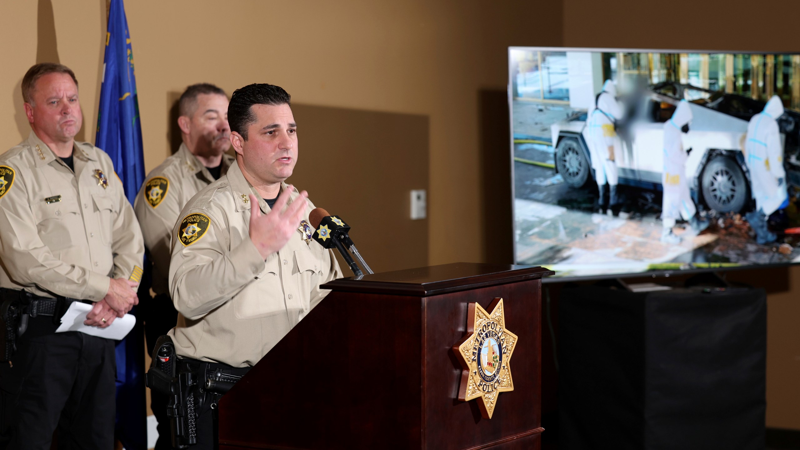 Metropolitan Police Department Assistant Sheriff Dori Koren shows a photo of the investigation into a Tesla Cybertruck that exploded at the Trump International Hotel, during a news conference at Metropolitan Police Department headquarters in Las Vegas, Tuesday, Jan. 7, 2025. (K.M. Cannon/Las Vegas Review-Journal via AP)