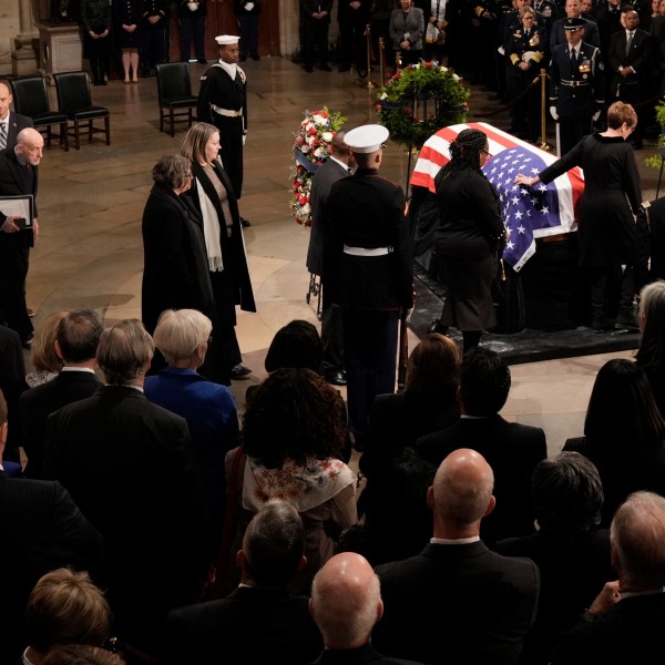 Members of the Carter family pay their respects as the flag-draped casket of former President Jimmy Carter lies in state at the U.S. Capitol, Tuesday, Jan. 7, 2025, in Washington. Carter died Dec. 29 at the age of 100. (AP Photo/J. Scott Applewhite, Pool)