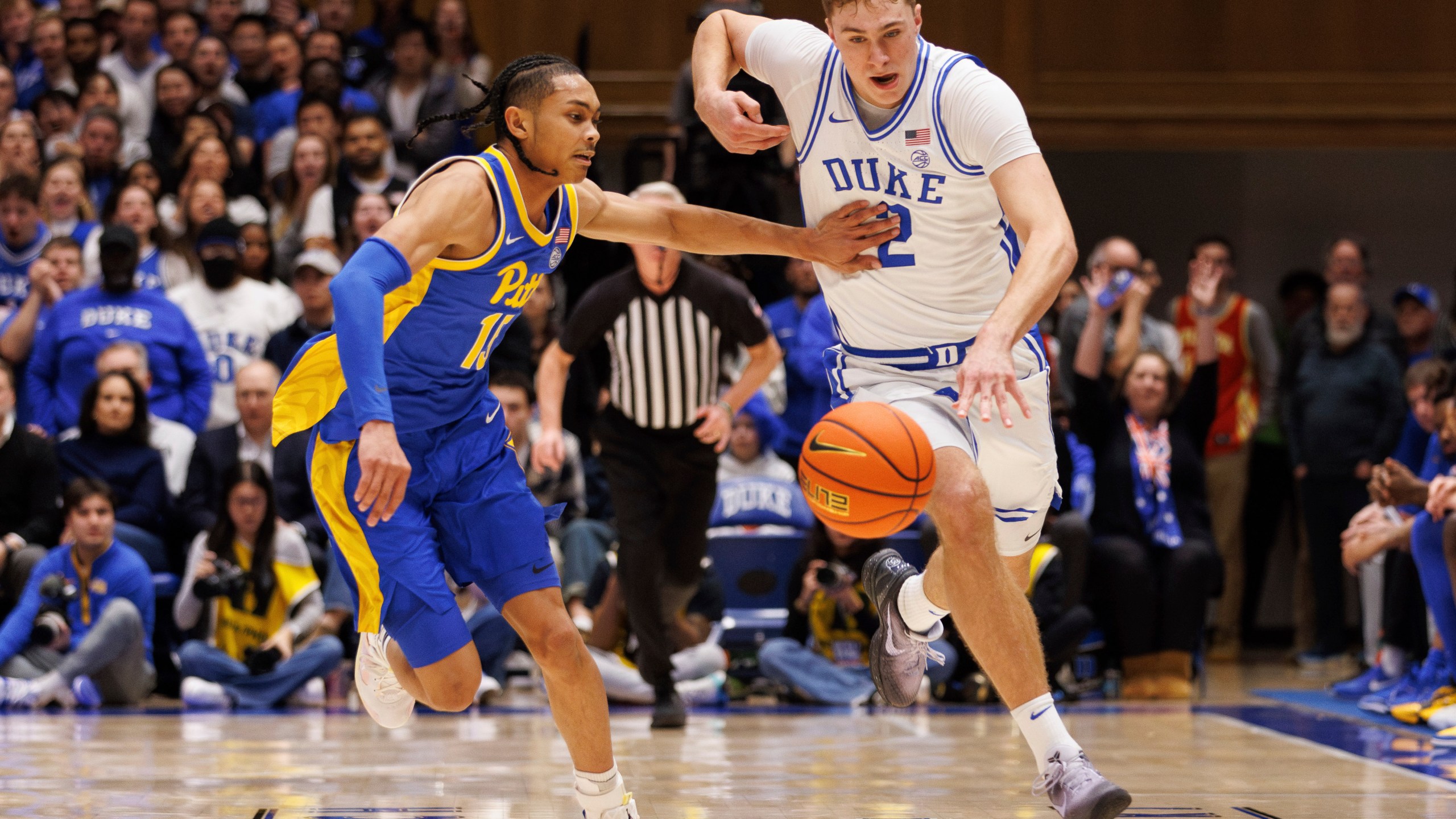 Duke's Cooper Flagg (2) gathers a loose ball for a fast break ahead of Pittsburgh's Jaland Love (15) during the second half of an NCAA college basketball game in Durham, N.C., Tuesday, Jan. 7, 2025. (AP Photo/Ben McKeown)