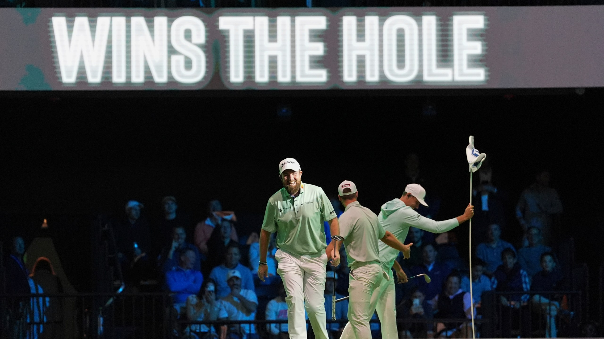 The Bay Golf Club's Shane Lowry, left, and teammates react as they beat New York Golf Club on the third hole, during the inaugural match of the TMRW Golf League, Tuesday, Jan. 7, 2025, in Palm Beach Gardens, Fla. TGL features six teams of four players competing against each other in a tech-infused arena the size of a football field. (AP Photo/Rebecca Blackwell)