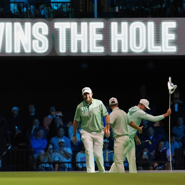 The Bay Golf Club's Shane Lowry, left, and teammates react as they beat New York Golf Club on the third hole, during the inaugural match of the TMRW Golf League, Tuesday, Jan. 7, 2025, in Palm Beach Gardens, Fla. TGL features six teams of four players competing against each other in a tech-infused arena the size of a football field. (AP Photo/Rebecca Blackwell)