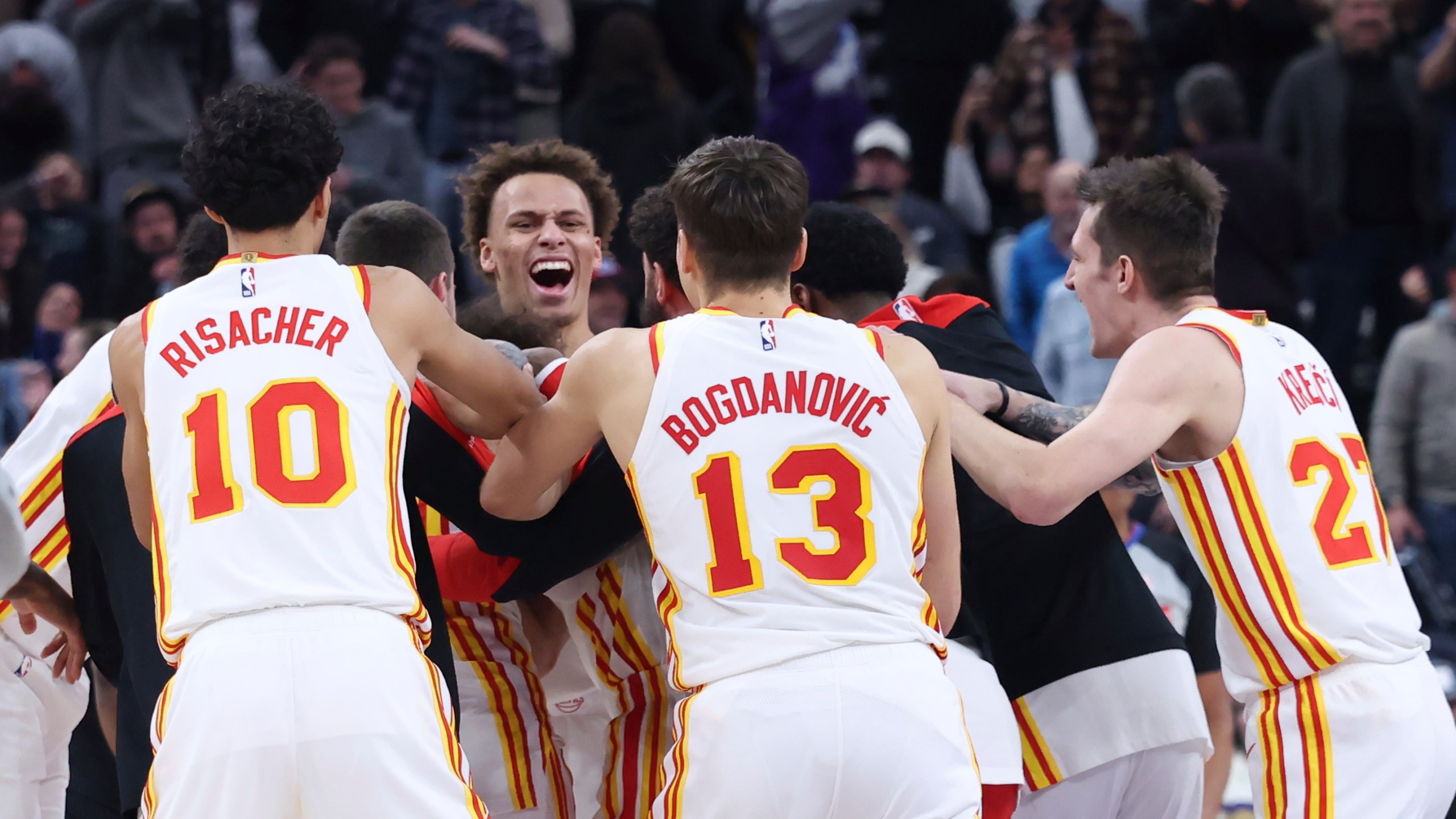 The Atlanta Hawks celebrate a game winning half court shot against the Utah Jazz during an NBA basketball game, Tuesday, Jan. 7, 2025, in Salt Lake City. (AP Photo/Rob Gray)