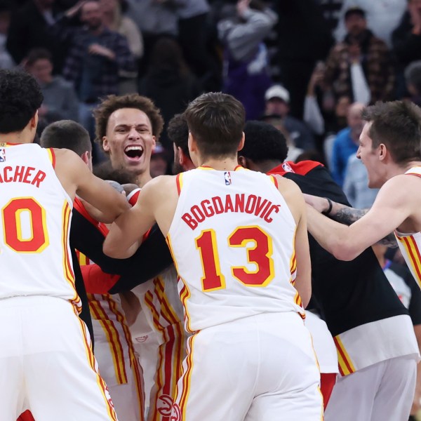 The Atlanta Hawks celebrate a game winning half court shot against the Utah Jazz during an NBA basketball game, Tuesday, Jan. 7, 2025, in Salt Lake City. (AP Photo/Rob Gray)