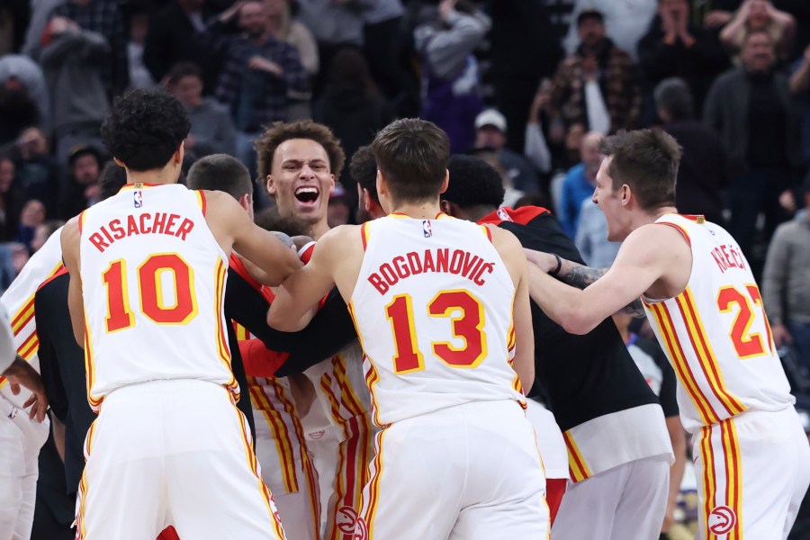 The Atlanta Hawks celebrate a game winning half court shot against the Utah Jazz during an NBA basketball game, Tuesday, Jan. 7, 2025, in Salt Lake City. (AP Photo/Rob Gray)