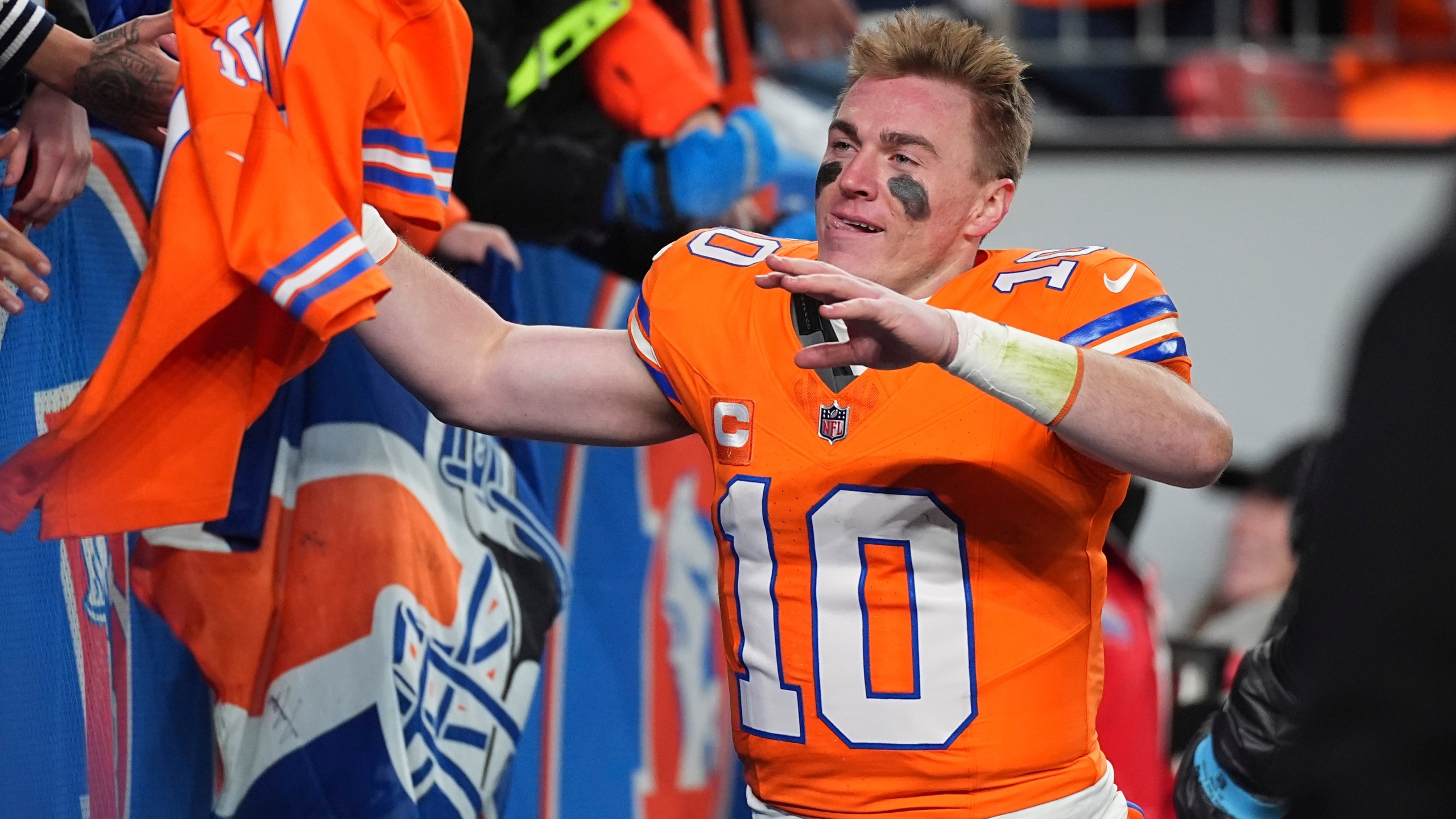 Fans congratulate Denver Broncos quarterback Bo Nix after an NFL football game against the Kansas City Chiefs, Sunday, Jan. 5, 2025, in Denver. (AP Photo/David Zalubowski)