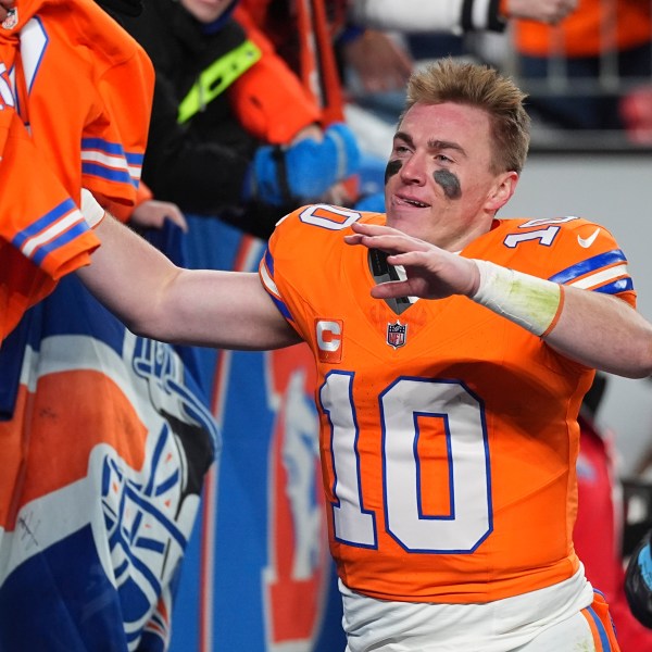 Fans congratulate Denver Broncos quarterback Bo Nix after an NFL football game against the Kansas City Chiefs, Sunday, Jan. 5, 2025, in Denver. (AP Photo/David Zalubowski)