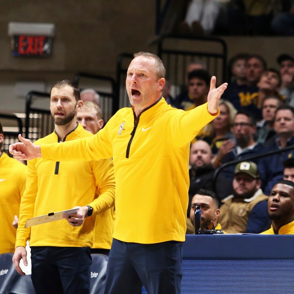 West Virginia coach Darian Devries reacts during the first half of an NCAA college basketball game against Arizona, Tuesday, Jan. 7, 2025, in Morgantown, W.Va. (AP Photo/Kathleen Batten)