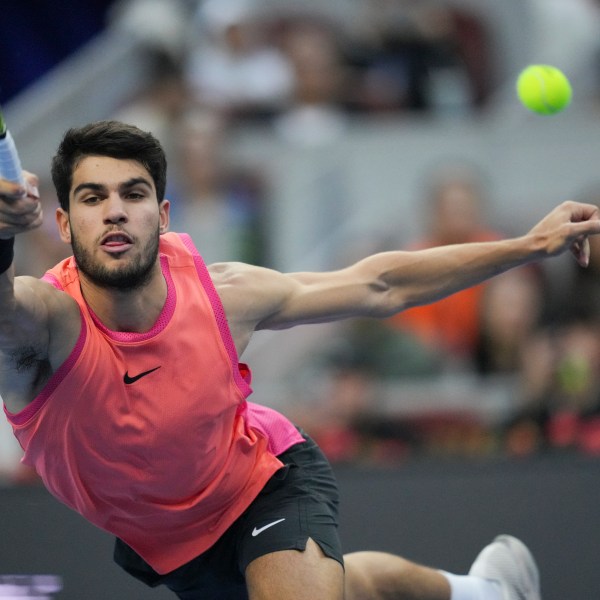 FILE - Carlos Alcaraz of Spain returns a shot from Jannik Sinner of Italy during their men's singles finals match of the China Open tennis tournament, at the National Tennis Center in Beijing, Wednesday, Oct. 2, 2024. (AP Photo/Achmad Ibrahim, File)