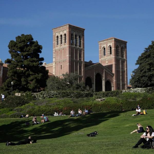 FILE - Students sit on the lawn near Royce Hall at the University of California, Los Angeles, in the Westwood section of Los Angeles on April 25, 2019. (AP Photo/Jae C. Hong, File)