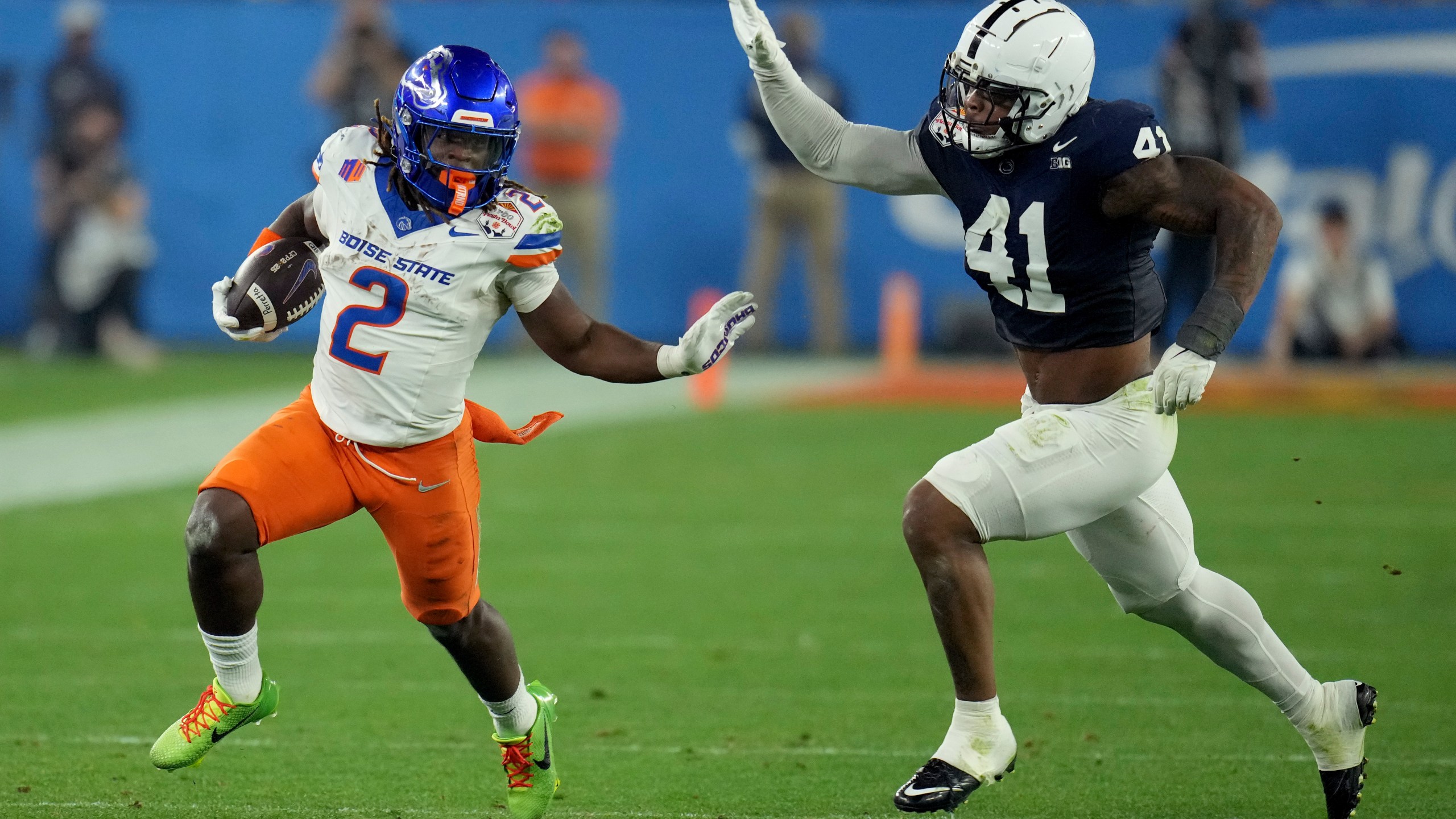 Boise State running back Ashton Jeanty (2) runs as Penn State linebacker Kobe King (41) pursues during the first half of the Fiesta Bowl College Football Playoff game, Tuesday, Dec. 31, 2024, in Glendale, Ariz. (AP Photo/Ross D. Franklin)