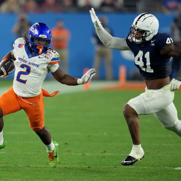 Boise State running back Ashton Jeanty (2) runs as Penn State linebacker Kobe King (41) pursues during the first half of the Fiesta Bowl College Football Playoff game, Tuesday, Dec. 31, 2024, in Glendale, Ariz. (AP Photo/Ross D. Franklin)