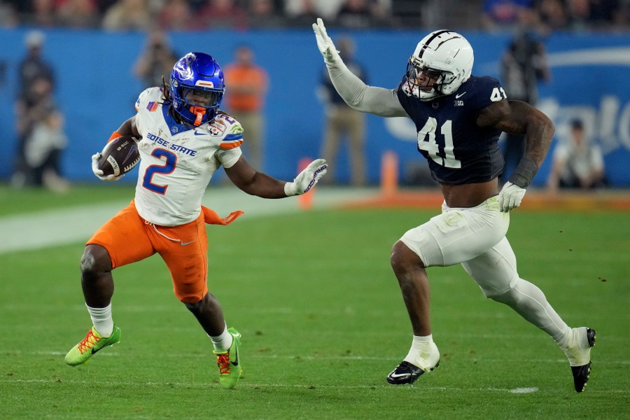 Boise State running back Ashton Jeanty (2) runs as Penn State linebacker Kobe King (41) pursues during the first half of the Fiesta Bowl College Football Playoff game, Tuesday, Dec. 31, 2024, in Glendale, Ariz. (AP Photo/Ross D. Franklin)