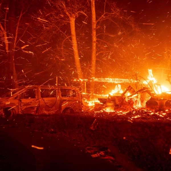 The Eaton Fire burns vehicles and structures Wednesday, Jan. 8, 2025 in Altadena, Calif. (AP Photo/Ethan Swope)