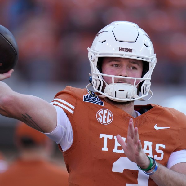 Texas quarterback Quinn Ewers warms up before a first round game against Clemson in the College Football Playoff, Saturday, Dec. 21, 2024, in Austin, Texas. (AP Photo/Eric Gay)