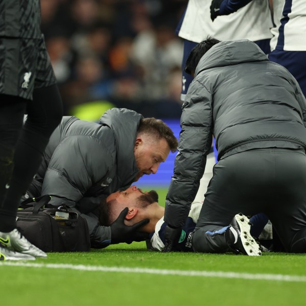 Tottenham's Rodrigo Bentancur receives medical treatment during the English League Cup semi final first leg soccer match between Tottenham and Liverpool, at the Tottenham Hotspur Stadium in London, Wednesday, Jan. 8, 2025. (AP Photo/Ian Walton)