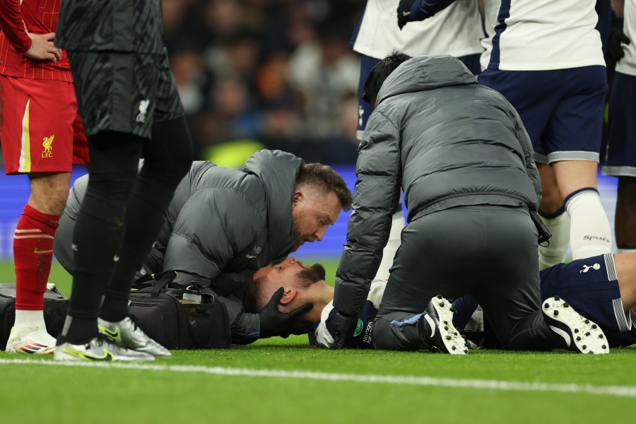 Tottenham's Rodrigo Bentancur receives medical treatment during the English League Cup semi final first leg soccer match between Tottenham and Liverpool, at the Tottenham Hotspur Stadium in London, Wednesday, Jan. 8, 2025. (AP Photo/Ian Walton)