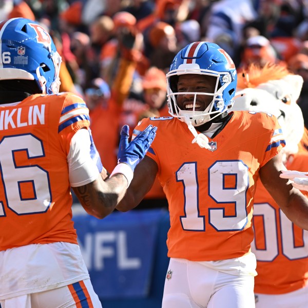 Denver Broncos wide receiver Marvin Mims Jr. (19) is congratulated by teammate Troy Franklin (16) after scoring during the first half of an NFL football game against the Kansas City Chiefs Sunday, Jan. 5, 2025, in Denver. (AP Photo/Geneva Heffernan)