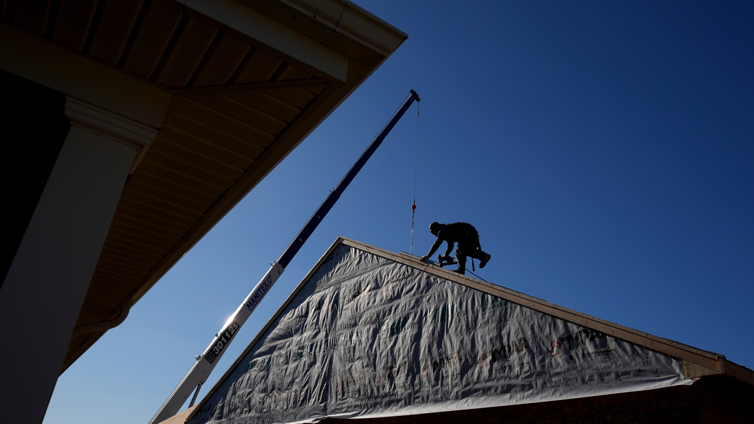 Construction workers frame a new single-family home Friday, Dec. 6, 2024, in Owensboro, Ky. (AP Photo/Charlie Riedel)