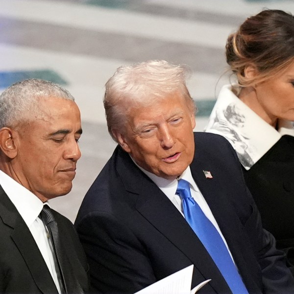 Former President Barack Obama talks with President-elect Donald Trump as Melania Trump reads the funeral program before the state funeral for former President Jimmy Carter at Washington National Cathedral in Washington, Thursday, Jan. 9, 2025. (AP Photo/Jacquelyn Martin)