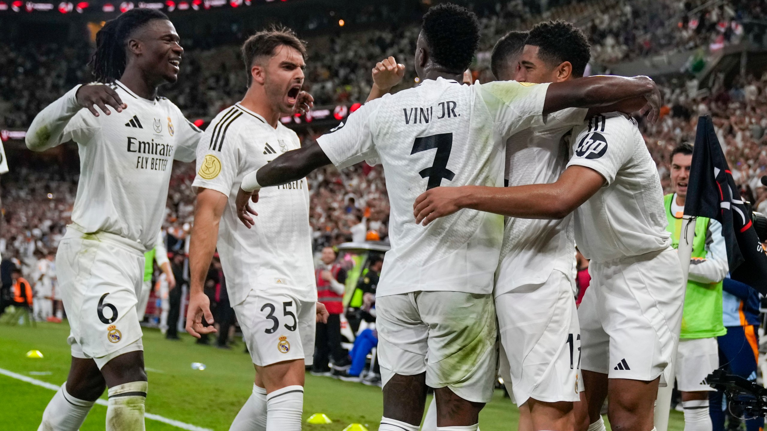 Real Madrid's Jude Bellingham, right, celebrates after scoring his side's opening goal during the Spanish Super Cup semifinal soccer match between Real Madrid and Mallorca at the King Abdullah Stadium in Jeddah, Saudi Arabia, Thursday, Jan. 9, 2025. (AP Photo/Altaf Qadri)