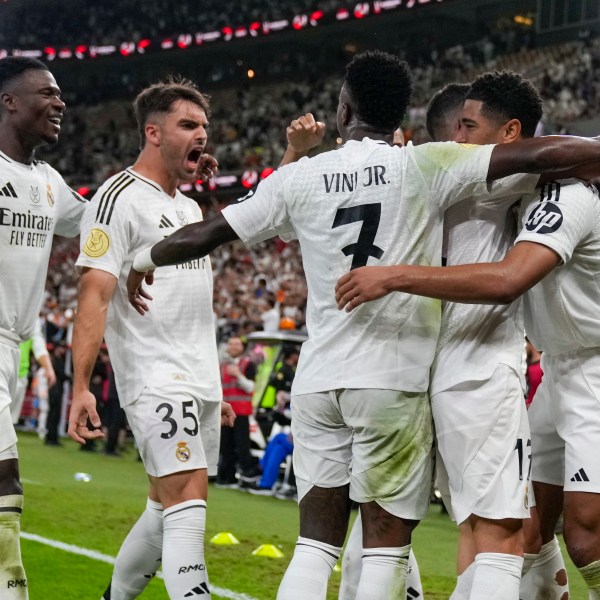 Real Madrid's Jude Bellingham, right, celebrates after scoring his side's opening goal during the Spanish Super Cup semifinal soccer match between Real Madrid and Mallorca at the King Abdullah Stadium in Jeddah, Saudi Arabia, Thursday, Jan. 9, 2025. (AP Photo/Altaf Qadri)