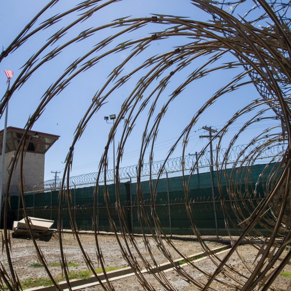 FILE - In this April 17, 2019, photo, reviewed by U.S. military officials, the control tower is seen through the razor wire inside the Camp VI detention facility in Guantanamo Bay Naval Base, Cuba. (AP Photo/Alex Brandon, File)