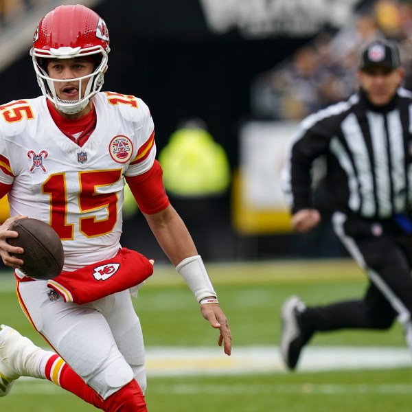 Kansas City Chiefs quarterback Patrick Mahomes (15) runs out of the backfield against the Pittsburgh Steelers during the first half of an NFL football game, Wednesday, Dec. 25, 2024, in Pittsburgh. (AP Photo/Matt Freed)