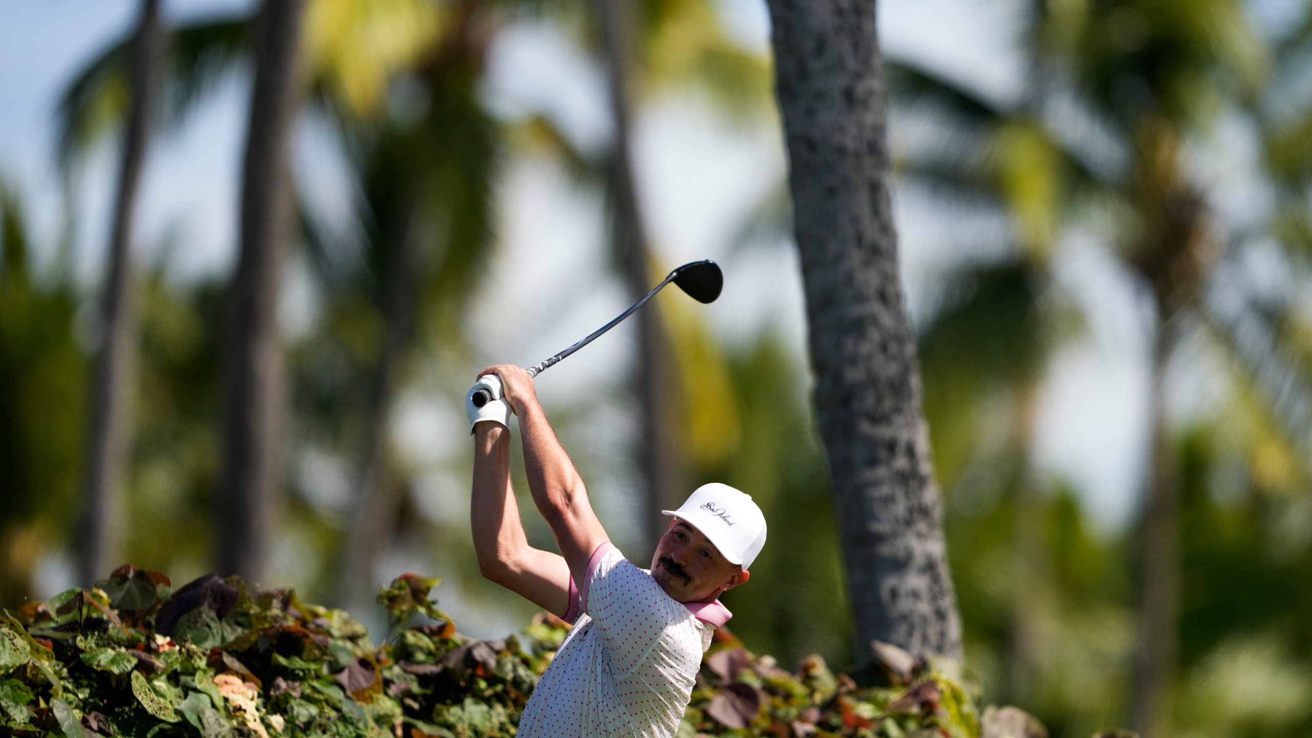 Paul Peterson hits on the 18th hole during the first round of the Sony Open golf event, Thursday, Jan. 9, 2025, at Waialae Country Club in Honolulu. (AP Photo/Matt York)