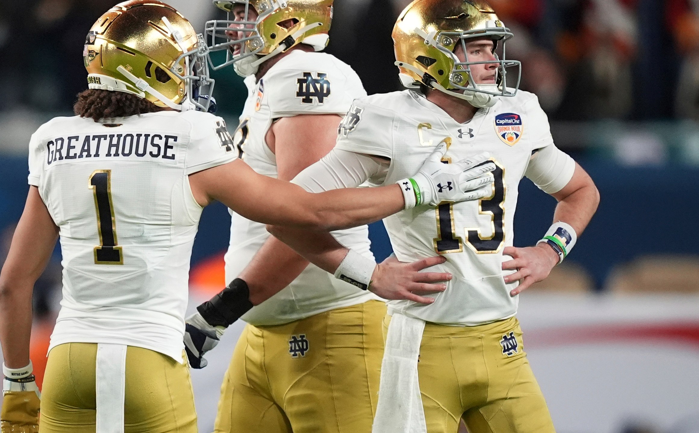 Notre Dame wide receiver Jaden Greathouse (1) reaches out to quarterback Riley Leonard (13) after he was sacked during the first half of the Orange Bowl NCAA College Football Playoff semifinal game against Penn State, Thursday, Jan. 9, 2025, in Miami Gardens, Fla. (AP Photo/Rebecca Blackwell)