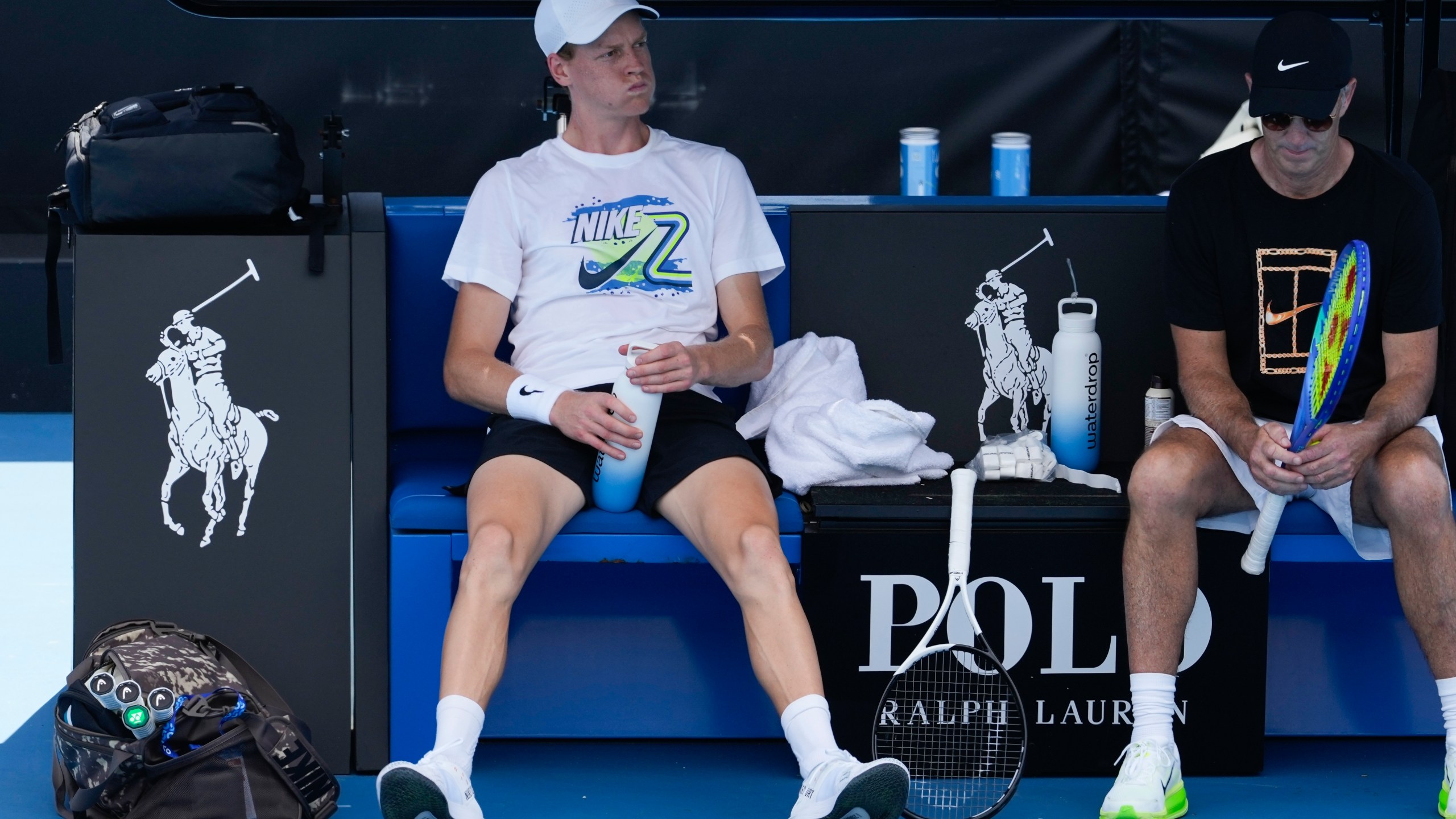 Italy's Jannik Sinner takes a break during a practice session ahead of the Australian Open tennis championship in Melbourne, Australia, Friday, Jan. 10, 2025. (AP Photo/Manish Swarup)